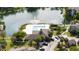 Picturesque view of a community pool and clubhouse located on a scenic lake with a fountain at 4708 Walden Cir # 37, Orlando, FL 32811