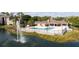Scenic community pool area near a serene lake and fountain at 4708 Walden Cir # 37, Orlando, FL 32811