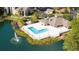 Community pool with lake, fountain, surrounding buildings and tropical palm trees at 4708 Walden Cir # 37, Orlando, FL 32811