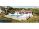 Community pool and clubhouse with well-maintained landscaping near lake at 4708 Walden Cir # 37, Orlando, FL 32811