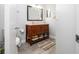 Bathroom boasting a wooden vanity with granite countertop and modern fixtures at 4708 Walden Cir # 37, Orlando, FL 32811