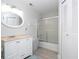 Bright bathroom with a vanity, shower with glass door, and a linen closet at 4708 Walden Cir # 37, Orlando, FL 32811