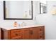 Close up of a granite bathroom vanity with a decorative mirror and modern fixtures at 4708 Walden Cir # 37, Orlando, FL 32811