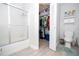 Bathroom featuring a tub with a glass enclosure, toilet, and closet at 4708 Walden Cir # 37, Orlando, FL 32811