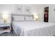 Bedroom featuring a queen bed, two nightstands, wood-look tile floors, and a walk in closet at 4708 Walden Cir # 37, Orlando, FL 32811