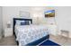 Cozy bedroom with a blue bed, patterned bedding, and a flat-screen TV at 4708 Walden Cir # 37, Orlando, FL 32811