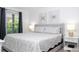 Comfortable bedroom showcasing a queen bed with patterned linens and bedside tables at 4708 Walden Cir # 37, Orlando, FL 32811