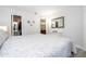 Bedroom featuring a queen bed, two nightstands, wood-look tile floors, and a walk-in closet and ensuite at 4708 Walden Cir # 37, Orlando, FL 32811