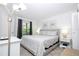 Bright bedroom featuring a queen bed, stylish bedding, and natural light at 4708 Walden Cir # 37, Orlando, FL 32811