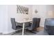Modern dining area with a stylish table and chairs next to a sectional couch at 4708 Walden Cir # 37, Orlando, FL 32811