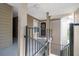Condo entrance featuring a black front door adorned with a decorative wreath and a black metal railing at 4708 Walden Cir # 37, Orlando, FL 32811