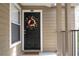 Close-up of the condo front door featuring a wreath; the house number is displayed above the door at 4708 Walden Cir # 37, Orlando, FL 32811