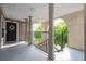 Condo entrance featuring a black front door decorated with a wreath, situated near a stairwell at 4708 Walden Cir # 37, Orlando, FL 32811