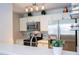Modern kitchen with stainless steel appliances and updated lighting at 4708 Walden Cir # 37, Orlando, FL 32811