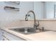 Close-up of the kitchen sink featuring modern fixtures and quartz countertops at 4708 Walden Cir # 37, Orlando, FL 32811
