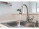 Kitchen sink and faucet showcasing a modern design and clean aesthetic with bright countertops at 4708 Walden Cir # 37, Orlando, FL 32811
