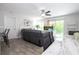 Cozy living room with a plush gray reclining sofa, ceiling fan, and sliding door to a balcony at 4708 Walden Cir # 37, Orlando, FL 32811