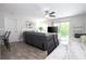 Cozy living room with a plush gray reclining sofa, ceiling fan, and sliding door to a balcony at 4708 Walden Cir # 37, Orlando, FL 32811