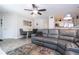 Open concept living room featuring a gray leather sectional and dining area at 4708 Walden Cir # 37, Orlando, FL 32811