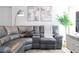 Stylish living room features a plush gray sectional and neutral decor at 4708 Walden Cir # 37, Orlando, FL 32811