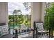 Serene balcony seating area overlooking lush greenery and tranquil water feature at 4708 Walden Cir # 37, Orlando, FL 32811
