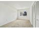 A bright bedroom features a large window and closet with carpeted floors at 4713 S Texas Ave # 4713D, Orlando, FL 32839