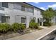 Inviting two-story condo with arched facade detail, manicured shrubbery, and walkway at 4713 S Texas Ave # 4713D, Orlando, FL 32839