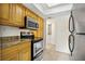 Modern kitchen features wood cabinets, granite counters, and stainless steel appliances at 4713 S Texas Ave # 4713D, Orlando, FL 32839