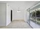 Light-filled living room with plush carpet and access to a private balcony at 4713 S Texas Ave # 4713D, Orlando, FL 32839