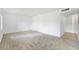 Open floor plan living room with neutral carpet and tile entryway at 4713 S Texas Ave # 4713D, Orlando, FL 32839