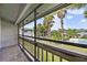 Screened patio overlooking the community pool, landscaping, and palm trees at 4713 S Texas Ave # 4713D, Orlando, FL 32839
