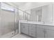 Bathroom featuring a glass enclosed shower, double sink vanity, and modern finishes at 503 Silver Palm Dr, Haines City, FL 33844
