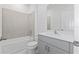 Bathroom with a tub and shower combo, gray vanity, and light tile at 503 Silver Palm Dr, Haines City, FL 33844