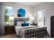 Comfortable bedroom with a decorative black headboard, soothing colors, and ample natural light, creating a relaxing atmosphere at 503 Silver Palm Dr, Haines City, FL 33844