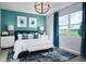 Stylish main bedroom features a large window, blue textured wall and luxurious furnishings, perfect for relaxation at 503 Silver Palm Dr, Haines City, FL 33844