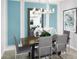 Elegant dining area featuring modern lighting, a large mirror and lovely blue accent wall at 503 Silver Palm Dr, Haines City, FL 33844
