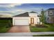 Charming one-story home featuring a brick driveway and a two-car garage, creating an inviting curb appeal at 503 Silver Palm Dr, Haines City, FL 33844