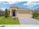Charming single-story home features a manicured lawn, paver driveway, and inviting front entrance at 503 Silver Palm Dr, Haines City, FL 33844