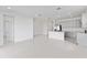 Bright open concept living space with white tile flooring and a kitchen with an island at 503 Silver Palm Dr, Haines City, FL 33844