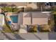 Aerial view of a home featuring a swimming pool, brick-paved patio, and well-manicured lawn at 509 Eastwood Ln, Daytona Beach, FL 32118
