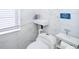 Modern bathroom featuring a minimalist sink and toilet with white marble walls at 509 Eastwood Ln, Daytona Beach, FL 32118