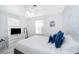 Bright bedroom with white walls, white tile floors, ceiling fan and comfortable bed at 509 Eastwood Ln, Daytona Beach, FL 32118
