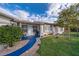Charming single story home with a brick walkway, blue accents, and mature landscaping at 509 Eastwood Ln, Daytona Beach, FL 32118