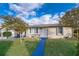 Well maintained home exterior with a brick walkway, blue accents, and a manicured front yard at 509 Eastwood Ln, Daytona Beach, FL 32118