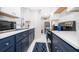 Galley kitchen features white cabinets, dark countertops and stainless steel appliances at 509 Eastwood Ln, Daytona Beach, FL 32118