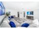Spacious living room with a large sectional sofa and modern decor with white tile floors at 509 Eastwood Ln, Daytona Beach, FL 32118