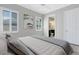 Comfortable bedroom with an ensuite bathroom and plenty of natural light from the windows at 5509 Meadow Hill Loop, Lady Lake, FL 32159