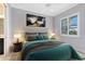 Comfortable bedroom features a ceiling fan, neutral colors, and ample natural light from the window at 5509 Meadow Hill Loop, Lady Lake, FL 32159