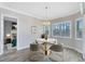Elegant dining area featuring a modern chandelier and views of the outdoors through plantation shutters at 5509 Meadow Hill Loop, Lady Lake, FL 32159