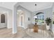 Charming dining area with a modern light fixture and large arched window, creating an inviting ambiance at 5509 Meadow Hill Loop, Lady Lake, FL 32159